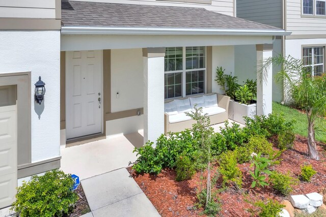 7639 Agrigento St, Clermont, FL 34714 - property entrance featuring a porch, a shingled roof, and stucco siding