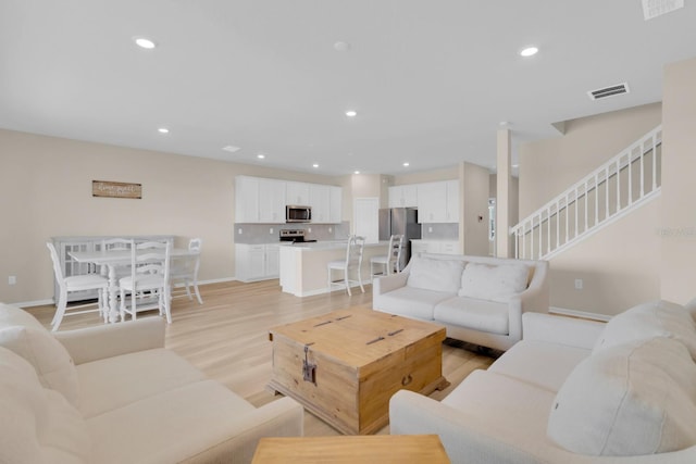 7639 Agrigento St, Clermont, FL 34714 - living area featuring stairs, light wood-type flooring, and recessed lighting
