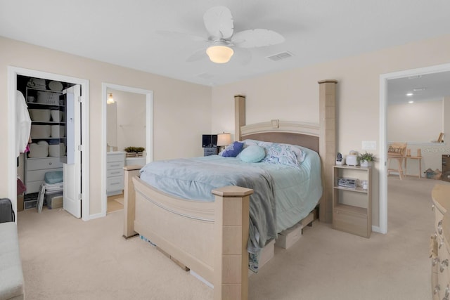 7639 Agrigento St, Clermont, FL 34714 - bedroom with light colored carpet, a spacious closet, ceiling fan, and ensuite bath