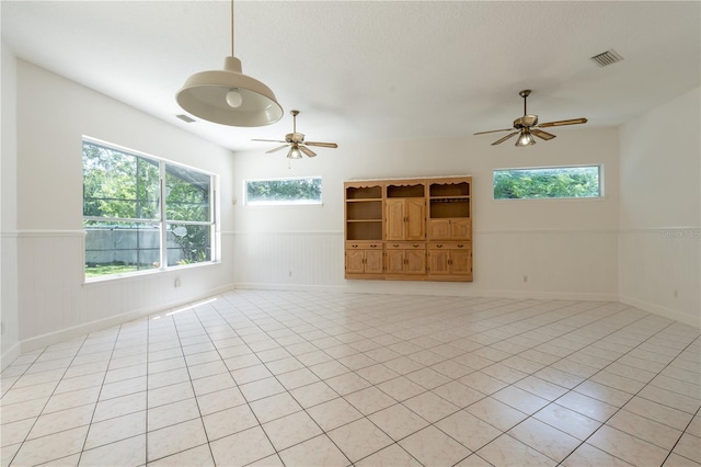 1586 Antoinette Ct, Oviedo, FL 32765 - unfurnished living room featuring a ceiling fan, a wainscoted wall, and light tile patterned flooring