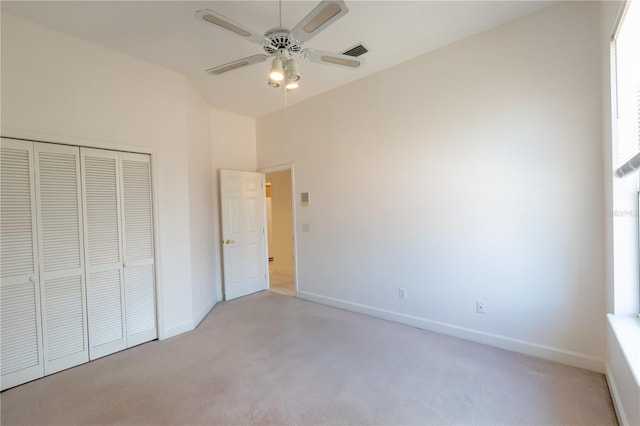 1586 Antoinette Ct, Oviedo, FL 32765 - unfurnished bedroom featuring light colored carpet, a closet, lofted ceiling, and a ceiling fan