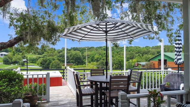 12434 Sullivan Rd, Clermont, FL 34715 - wooden deck featuring outdoor dining area and a forest view