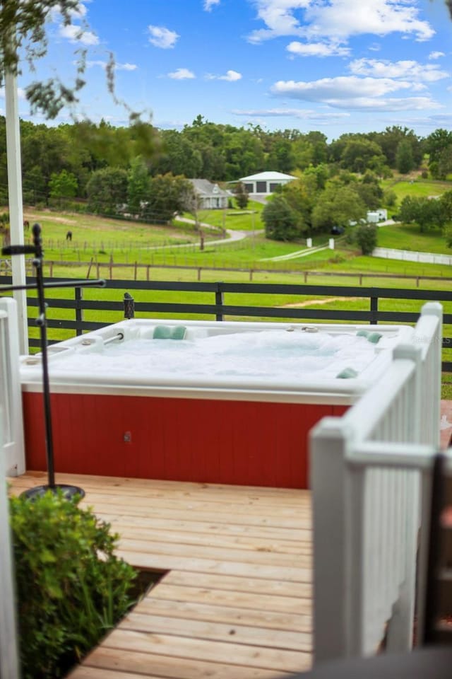 12434 Sullivan Rd, Clermont, FL 34715 - wooden terrace with a hot tub and view of wooded area