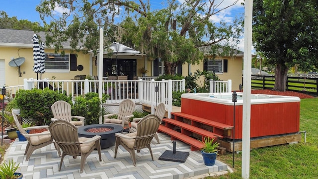 12434 Sullivan Rd, Clermont, FL 34715 - back of house featuring a hot tub, an outdoor fire pit, a patio, and stucco siding