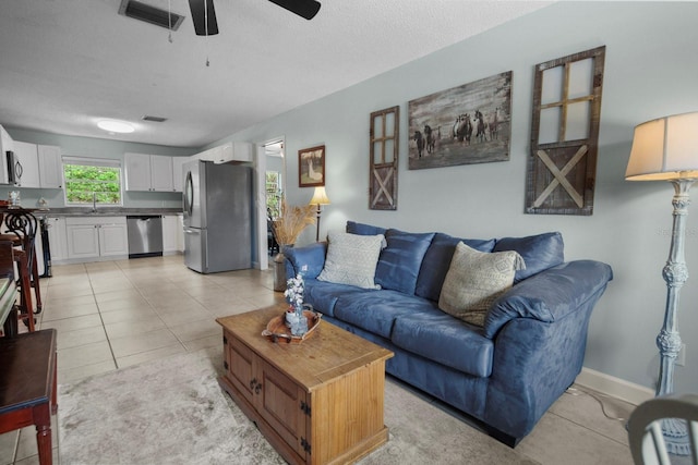 12434 Sullivan Rd, Clermont, FL 34715 - living area featuring a ceiling fan, light tile patterned flooring, and a textured ceiling