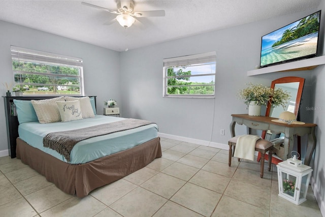 12434 Sullivan Rd, Clermont, FL 34715 - bedroom with multiple windows, light tile patterned floors, a textured ceiling, and a ceiling fan
