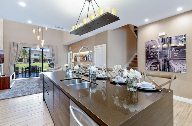 7461 Bleecker Ln, Kissimmee, FL 34747 - kitchen with open floor plan, dishwasher, light wood finished floors, a spacious island, and dark stone countertops