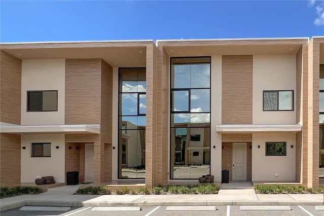 7461 Bleecker Ln, Kissimmee, FL 34747 - view of property featuring uncovered parking and stucco siding