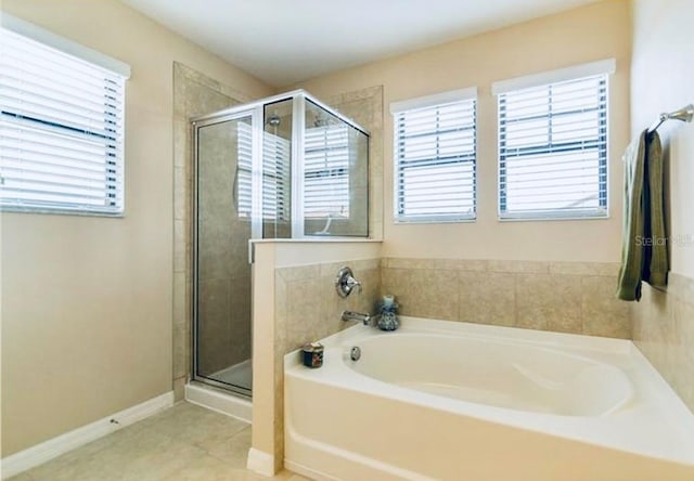 312 Partridge Pea Ln, Ocoee, FL 34761 - full bath featuring a bath, a shower stall, and tile patterned flooring