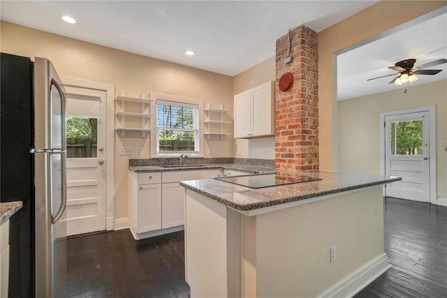 1201 S Myrtle Ave, Sanford, FL 32771 - kitchen with freestanding refrigerator, black electric stovetop, healthy amount of natural light, dark wood-style floors, and recessed lighting