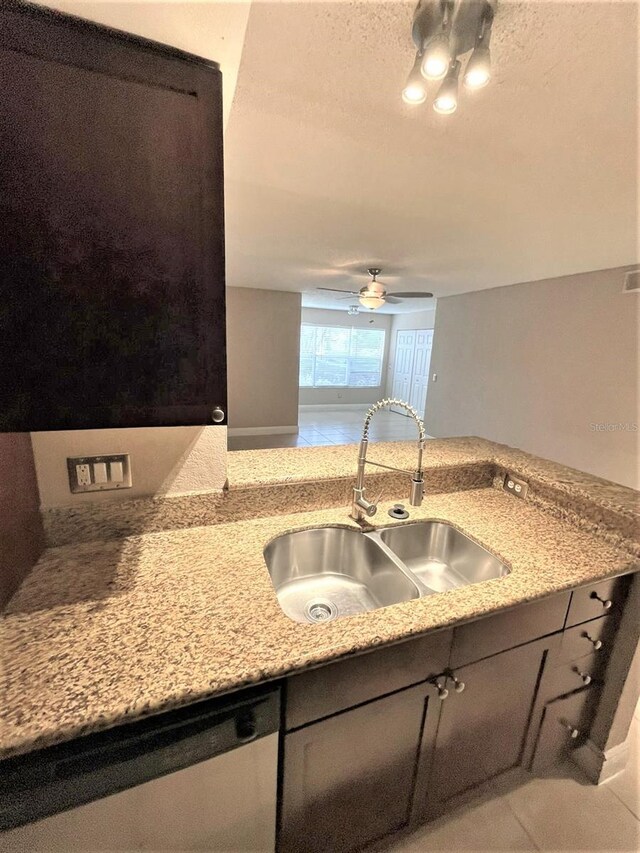 5116 Conroy Rd Unit 411, Orlando, FL 32811 - kitchen featuring a sink, ceiling fan, dishwasher, light stone countertops, and light tile patterned floors