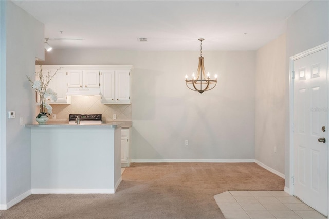 1400 Lake Shadow Cir Unit 10104, Maitland, FL 32751 - kitchen featuring light carpet, a chandelier, ventilation hood, light countertops, and backsplash