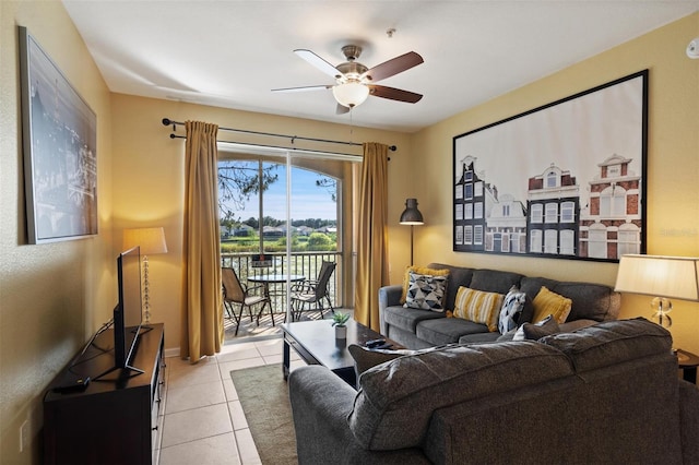7660 Comrow St Unit 203, Kissimmee, FL 34747 - living room featuring a ceiling fan, light tile patterned floors, and baseboards