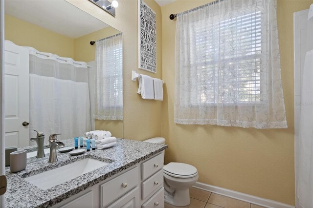 7660 Comrow St Unit 203, Kissimmee, FL 34747 - bathroom featuring vanity, tile patterned floors, toilet, and baseboards