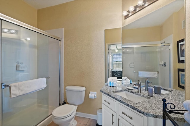 7660 Comrow St Unit 203, Kissimmee, FL 34747 - bathroom with toilet, a textured wall, vanity, a stall shower, and tile patterned flooring