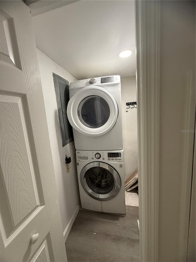 4674 Pembrook Pl Unit J 101, Orlando, FL 32811 - washroom featuring stacked washer / drying machine and wood finished floors