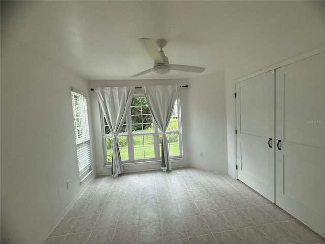 4674 Pembrook Pl Unit J 101, Orlando, FL 32811 - unfurnished bedroom featuring a ceiling fan, tile patterned floors, and a closet