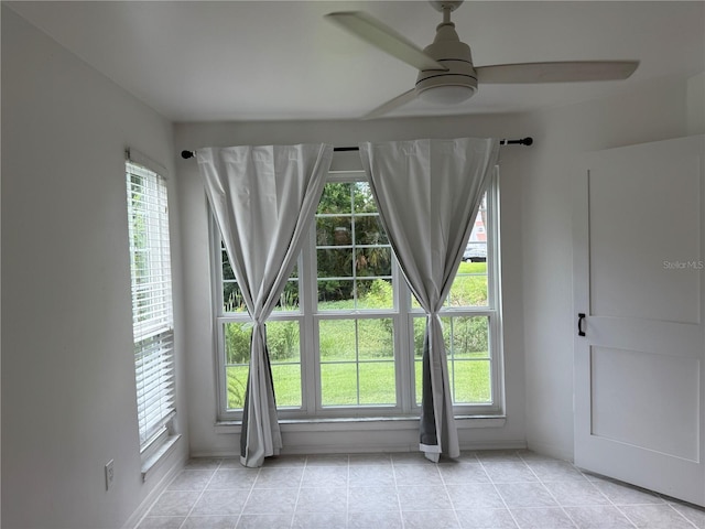 4674 Pembrook Pl Unit J 101, Orlando, FL 32811 - empty room featuring ceiling fan, plenty of natural light, and light tile patterned floors