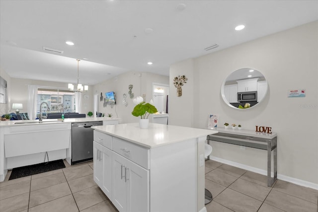 3180 Paradox Cir Unit 304, Kissimmee, FL 34746 - kitchen featuring stainless steel appliances, a sink, a center island, light tile patterned floors, and recessed lighting