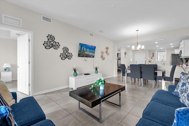 3180 Paradox Cir Unit 304, Kissimmee, FL 34746 - living room with a chandelier, light tile patterned flooring, recessed lighting, and baseboards