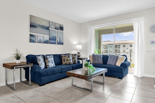 3180 Paradox Cir Unit 304, Kissimmee, FL 34746 - living room featuring baseboards and light tile patterned floors