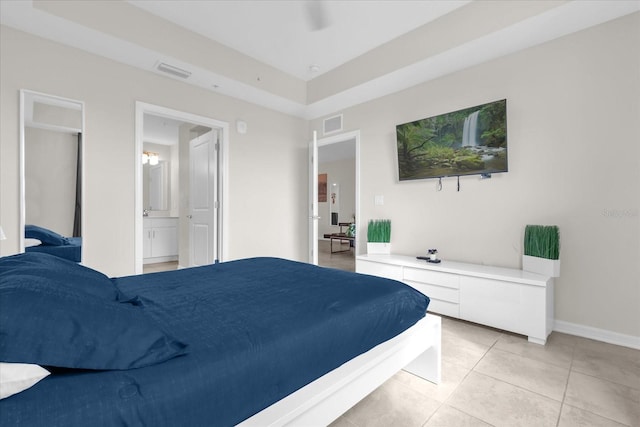 3180 Paradox Cir Unit 304, Kissimmee, FL 34746 - bedroom with light tile patterned floors, baseboards, ensuite bath, and ceiling fan