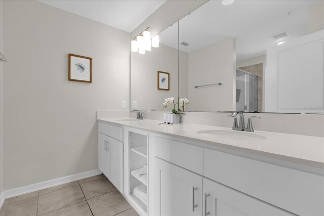 3180 Paradox Cir Unit 304, Kissimmee, FL 34746 - bathroom with double vanity, a stall shower, tile patterned flooring, and baseboards