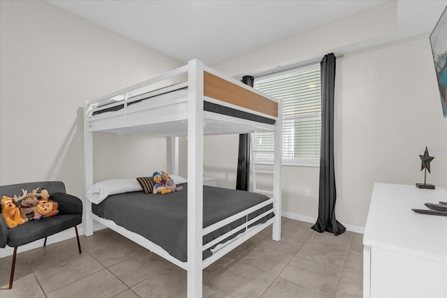 3180 Paradox Cir Unit 304, Kissimmee, FL 34746 - bedroom featuring light tile patterned flooring and baseboards