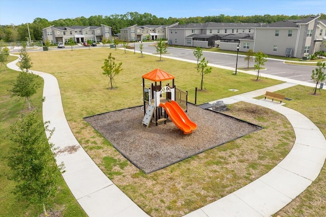 3180 Paradox Cir Unit 304, Kissimmee, FL 34746 - community play area with a residential view and a lawn