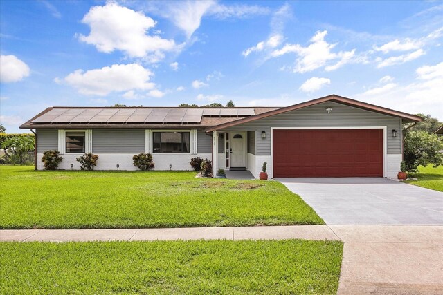 930 Chickadee Dr, Port Orange, FL 32127 - ranch-style home with an attached garage, roof mounted solar panels, a front lawn, driveway, and brick siding