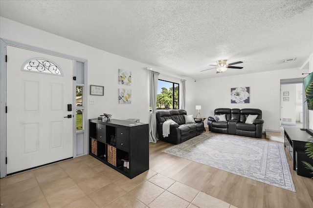 930 Chickadee Dr, Port Orange, FL 32127 - foyer entrance with a textured ceiling, a ceiling fan, and light tile patterned floors