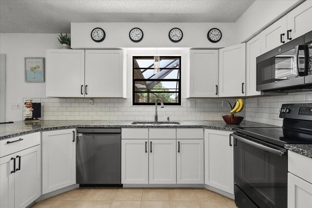930 Chickadee Dr, Port Orange, FL 32127 - kitchen with black / electric stove, stainless steel dishwasher, a sink, decorative backsplash, and dark stone counters