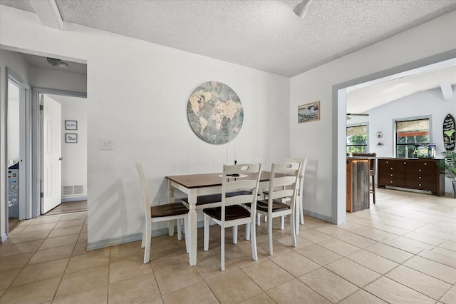 930 Chickadee Dr, Port Orange, FL 32127 - dining area featuring light tile patterned floors, a textured ceiling, and baseboards