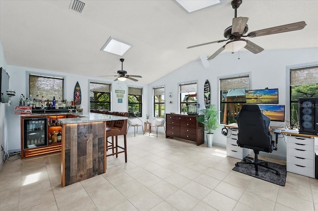 930 Chickadee Dr, Port Orange, FL 32127 - office with a skylight, wine cooler, ceiling fan, lofted ceiling, and light tile patterned flooring