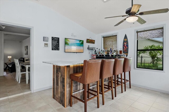 930 Chickadee Dr, Port Orange, FL 32127 - indoor dry bar featuring lofted ceiling, ceiling fan, baseboards, and light tile patterned floors
