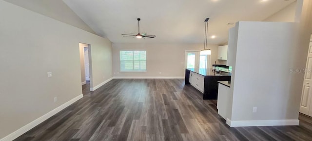 5118 Log Wagon Rd, Ocoee, FL 34761 - kitchen featuring vaulted ceiling, ceiling fan, white cabinetry, dark wood-type flooring, and baseboards