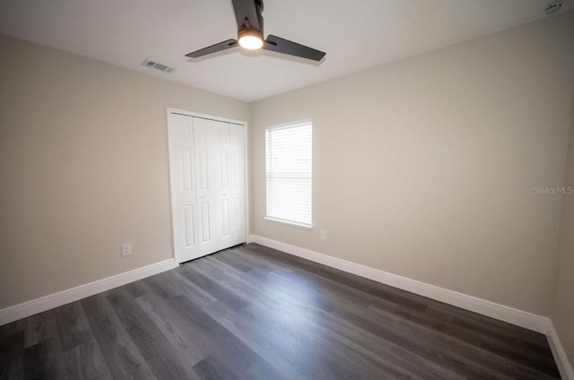 5118 Log Wagon Rd, Ocoee, FL 34761 - unfurnished bedroom with baseboards, dark wood-style flooring, a closet, and ceiling fan