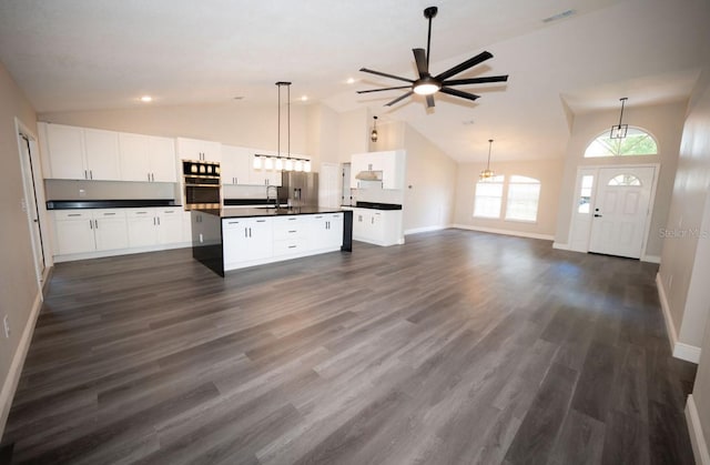 5118 Log Wagon Rd, Ocoee, FL 34761 - kitchen featuring appliances with stainless steel finishes, dark countertops, baseboards, ceiling fan, and high vaulted ceiling