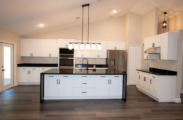 5118 Log Wagon Rd, Ocoee, FL 34761 - kitchen with appliances with stainless steel finishes, dark countertops, a sink, dark wood-type flooring, and high vaulted ceiling