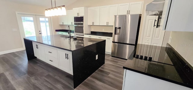 5118 Log Wagon Rd, Ocoee, FL 34761 - kitchen with appliances with stainless steel finishes, dark wood-type flooring, a sink, white cabinetry, and vaulted ceiling