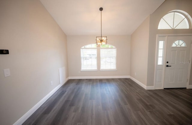 5118 Log Wagon Rd, Ocoee, FL 34761 - foyer entrance with vaulted ceiling, a chandelier, dark wood-type flooring, and baseboards