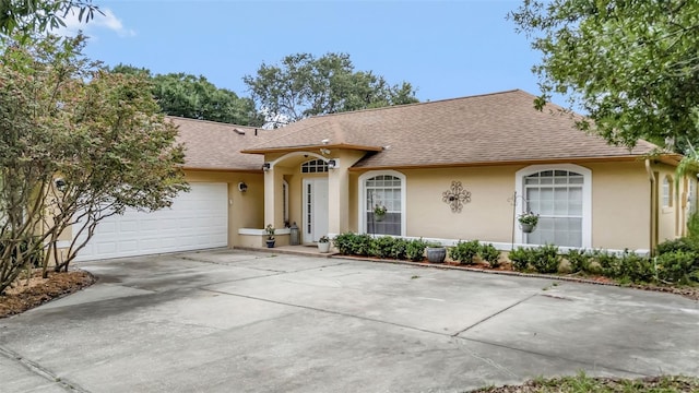 10711 Lake Hill Dr, Clermont, FL 34711 - view of front of property with stucco siding, roof with shingles, a garage, and concrete driveway