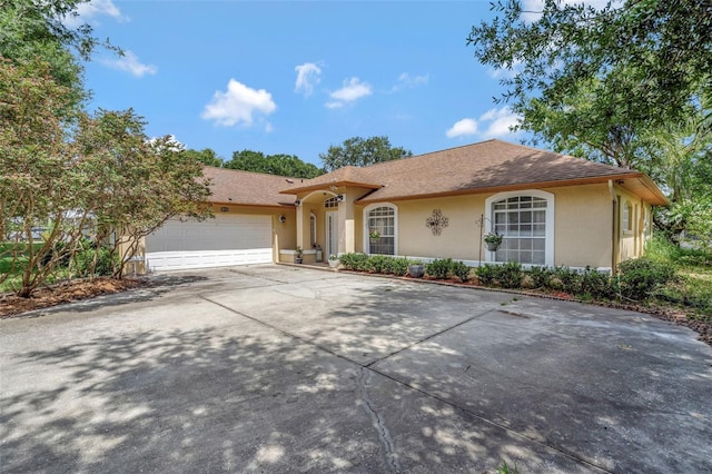 10711 Lake Hill Dr, Clermont, FL 34711 - view of front of property featuring stucco siding, concrete driveway, a garage, and a shingled roof