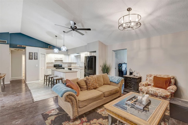 10711 Lake Hill Dr, Clermont, FL 34711 - living area featuring vaulted ceiling, a ceiling fan, wood finished floors, a chandelier, and a textured ceiling