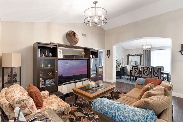 10711 Lake Hill Dr, Clermont, FL 34711 - living room with a chandelier, arched walkways, lofted ceiling, and wood finished floors