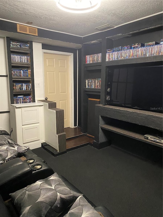 10711 Lake Hill Dr, Clermont, FL 34711 - interior space featuring a textured ceiling, built in shelves, and dark colored carpet