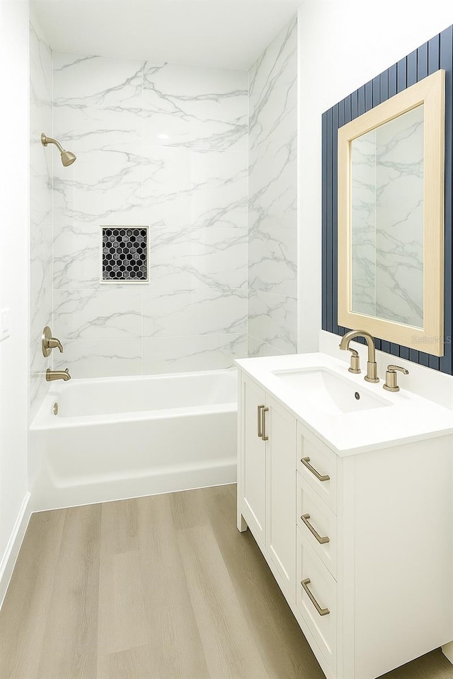 313 Bass Ct, Kissimmee, FL 34759 - full bathroom featuring vanity, wood finished floors, and tub / shower combination