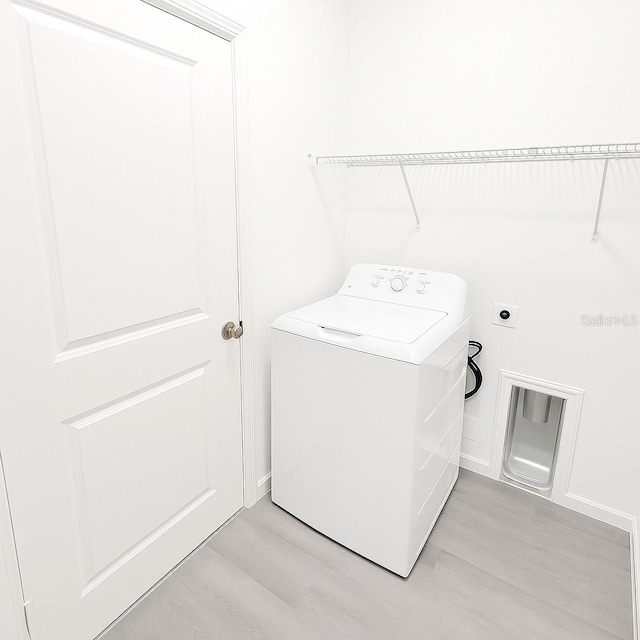 313 Bass Ct, Kissimmee, FL 34759 - laundry room with washer / dryer and light wood-type flooring