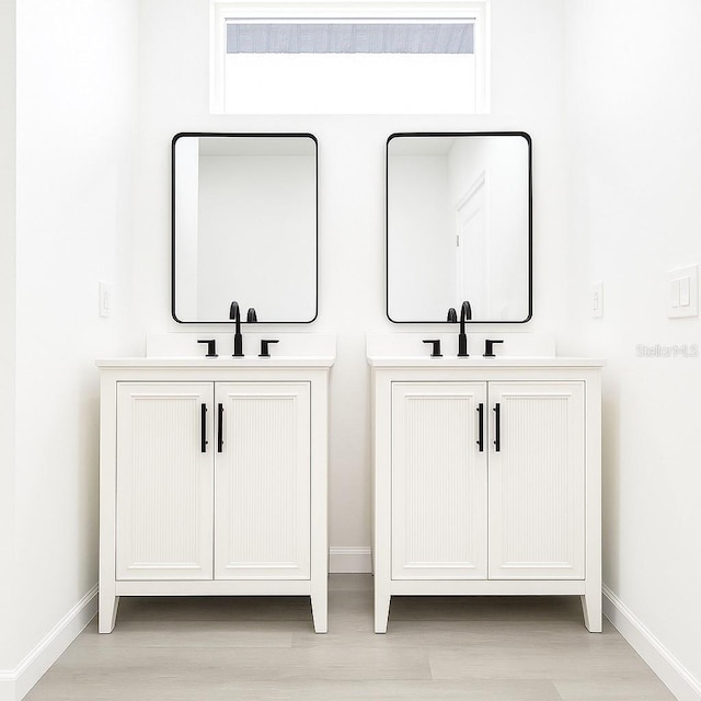 313 Bass Ct, Kissimmee, FL 34759 - bathroom view of two vanities and wood finished floors