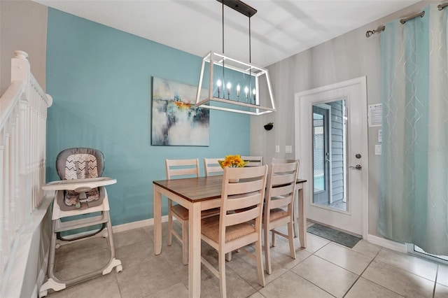 720 Gardenia Ln, Davenport, FL 33897 - tiled dining space featuring a chandelier and baseboards